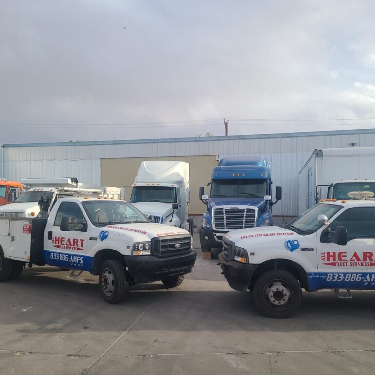 Fleet service trucks and semi trucks parked outside a diesel repair shop