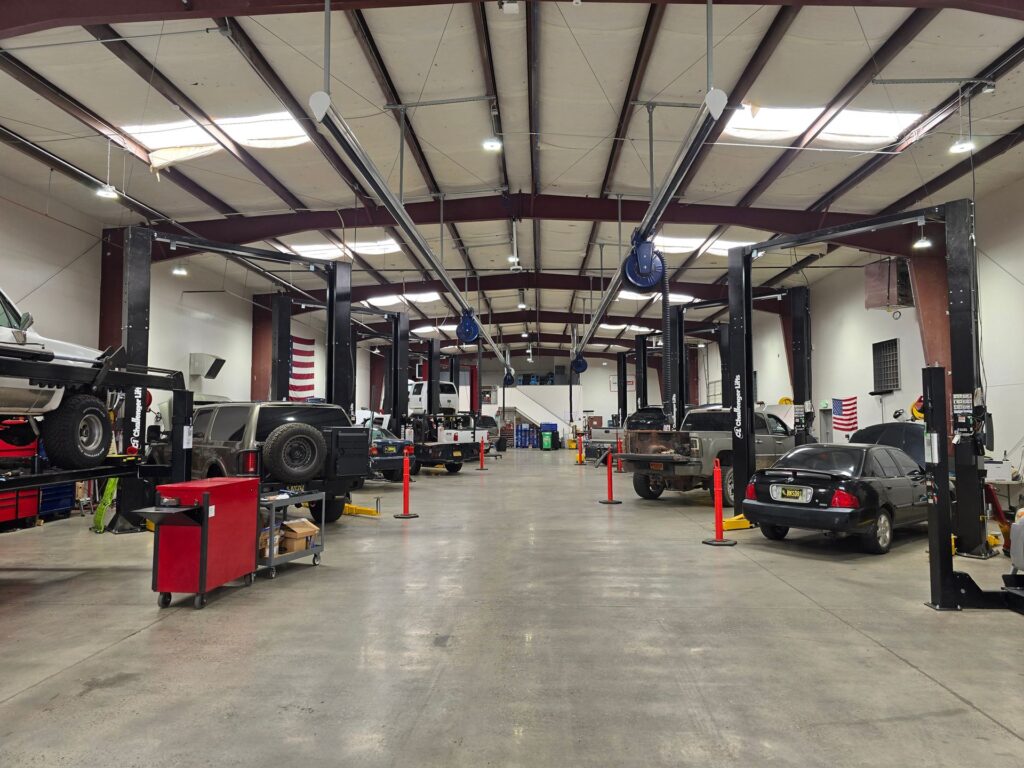 Inside a diesel repair shop with trucks on lifts in the service bays
