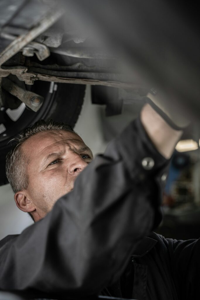 Diesel mechanic working under a truck